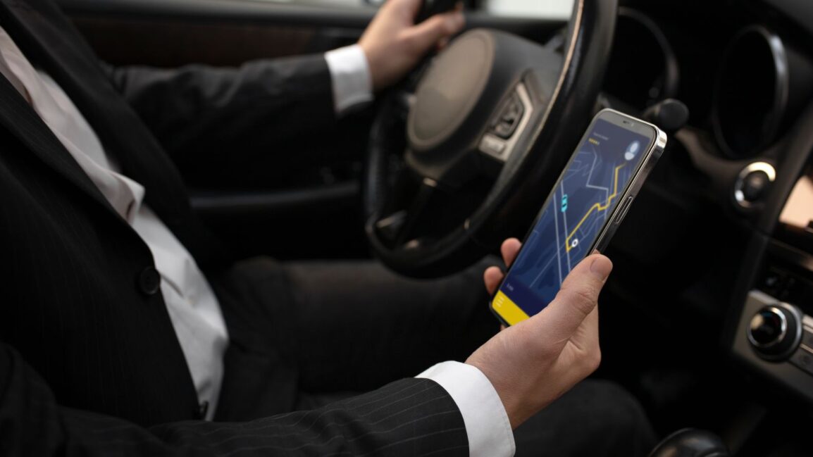 A driver checking his GPS tracking dashboard for enable security features for vehicle